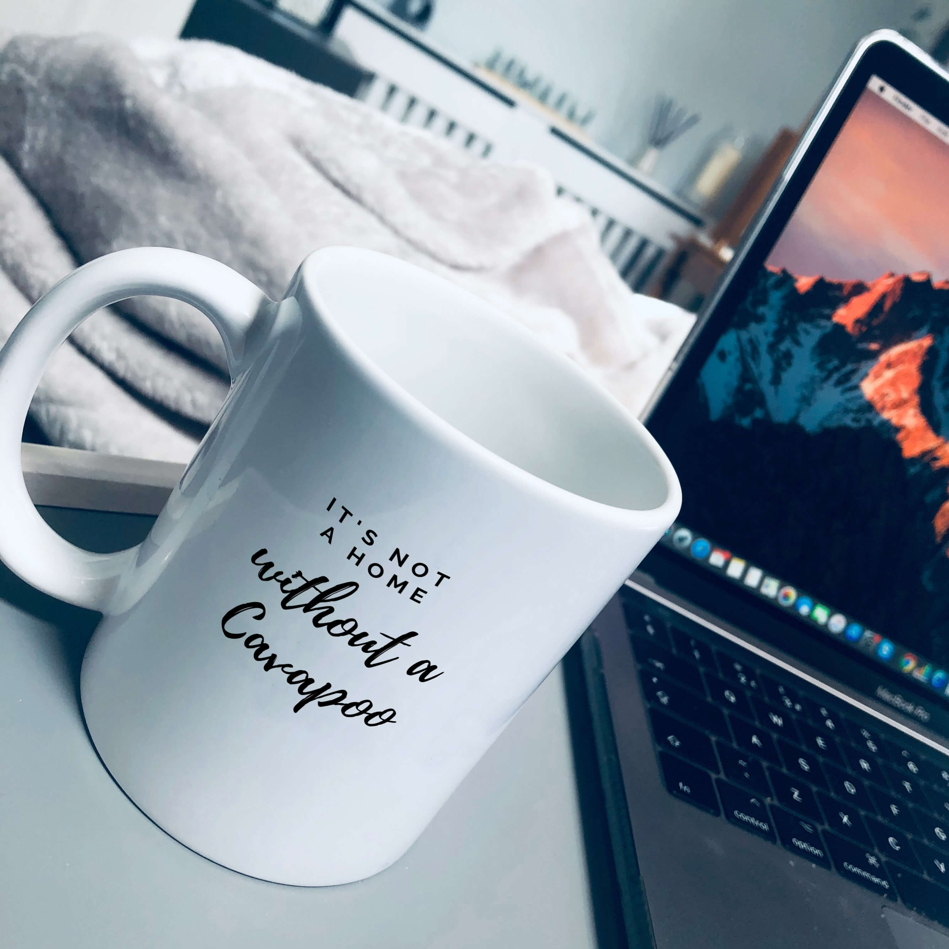 Mug with text on that says: It's not a home without a cavapoo